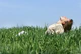 young girl relaxing in green grass