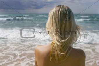 girl looking into stormy sea