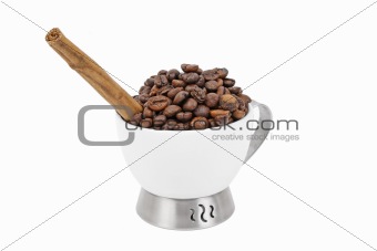 Cup of coffe beans and cinnamon stick