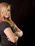 Young proud teenage girl posing on black background