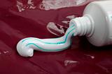 Toothpaste on red surface