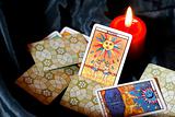 Burning candle and tarot cards-sun and moon