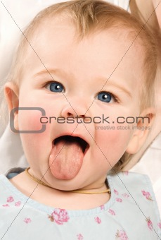 The baby shows out the tongue