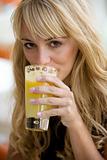Pretty woman drinking a glass of orange juice
