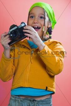 Excited girl holding a camera