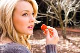 Beautiful woman eating strawberries