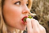Beautiful woman eating strawberries
