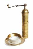 Elegant coffee cup and old brass manual mill