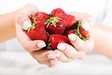 Beautiful hand with fresh strawberry