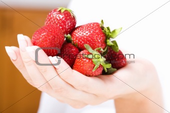 Beautiful hand with fresh strawberry