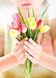 Beautiful hands with bunch of tulips