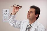 Optometrist inspecting eye glasses