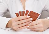 Woman's hands holding playing cards