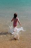 Girl running into the water