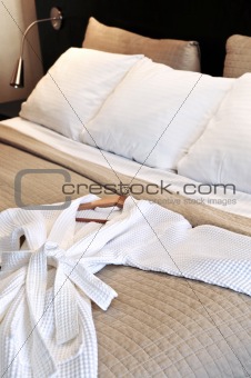 Hotel bed with bathrobe