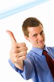 Young businessman showing thumb up. Sign "Yes"