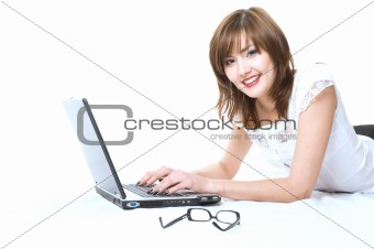 Young japanese businesswoman with laptop lying on the floor