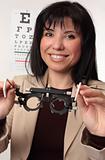 Optometrist holding trial frames