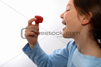 Young girls eats strawberry