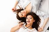 Two businesswomen have fun lying on the floor