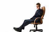 Businessman sitting on an armchair with cell phone.