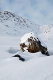 Snowbound boulder