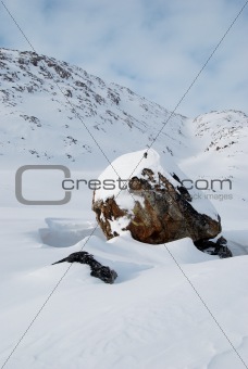 Snowbound boulder
