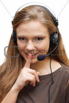 pretty customer services lady wearing headset shows gesture "keep silence"