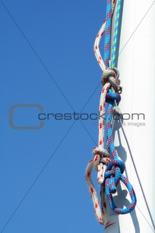 Rigging. Blue sky and white mast. 