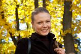 outdoor portrait of a pretty girl on autumn background.
