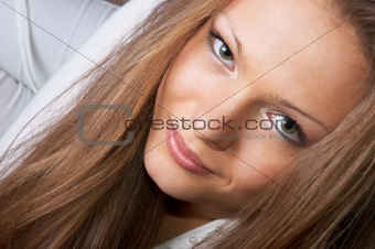 gaze of pretty long-haired girl in white. facial closeup.