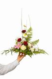 beautiful bouquet held by man's left hand. isolated on white.