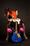 Two rock girls with bass guitar
