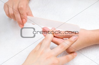applying manicure with nail-file