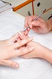 applying manicure - cuticle cleaning