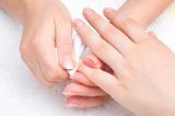 manicure applying - wiping the mosturizer from cuticles