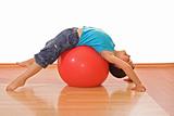 Boy playing with a gymnastic ball