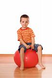 Serious boy with gymnastic ball