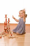 Happy little girl with wooden blocks
