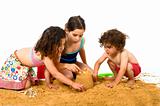 three kids playing in the sand