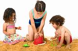 three kids playing in the sand