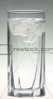 Ice water glass on grey