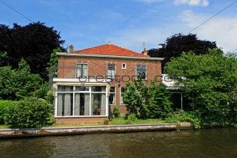 Dutch house, canal and trees