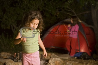 two girls at a camp site