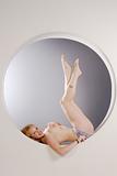 voluptuous blonde woman topless in pin-up pose
