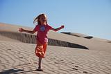 Young Girl Playing on Sand Dunes
