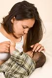 Beautiful Asian mom breastfeeding her baby boy