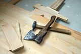 Hammer and axe on wooden to a floor