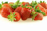 Lots of fresh ripe strawberries over white background