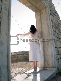 Barefoot Girl Looking Straight Holding Ancient Ruins